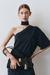 Profile view of model wearing the Oroton One Shoulder Dress in North Sea and 100% cotton fabric for Women .