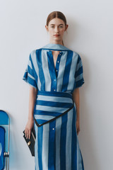 Profile view of model wearing the Oroton Slub Silk Stripe Column Dress in Azure Blue and 100% silk fabric for Women .