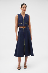 Profile view of model wearing the Oroton Zip Midi Skirt in North Sea and 100% cotton fabric for Women .