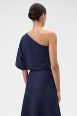 Profile view of model wearing the Oroton One Shoulder Top in North Sea and 100% cotton fabric for Women .