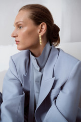 Profile view of model wearing the Oroton Chloe Earrings in Worn Gold and 14k yellow gold-plated brass with Oroton’s signature soft-burnished finish for Women .