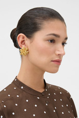 Profile view of model wearing the Oroton Wheat Statement Studs in Worn Gold and Brass for Women .