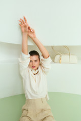 Profile view of model wearing the Oroton Half Placket Zip Shirt in Milk and 77% Viscose, 23% polyamide for Women .