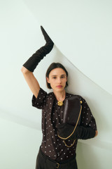 Profile view of model wearing the Oroton Graphic Spot Top in Dark Chocolate and 100% Silk for Women .