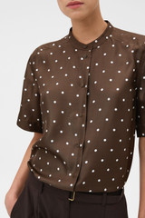 Profile view of model wearing the Oroton Graphic Spot Top in Dark Chocolate and 100% Silk for Women .