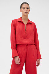 Profile view of model wearing the Oroton Half Placket Zip Shirt in Ribbon Red and 77% Viscose, 23% polyamide for Women .