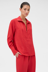 Profile view of model wearing the Oroton Half Placket Zip Shirt in Ribbon Red and 77% Viscose, 23% polyamide for Women .