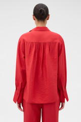 Profile view of model wearing the Oroton Half Placket Zip Shirt in Ribbon Red and 77% Viscose, 23% polyamide for Women .