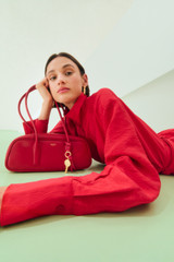 Profile view of model wearing the Oroton Half Placket Zip Shirt in Ribbon Red and 77% Viscose, 23% polyamide for Women .