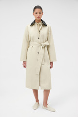 Profile view of model wearing the Oroton Essential Mac in Limestone and 77% cotton and 23% linen blend fabric body with a 100% leather collar for Women .