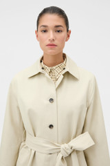 Profile view of model wearing the Oroton Essential Mac in Limestone and 77% cotton and 23% linen blend fabric body with a 100% leather collar for Women .