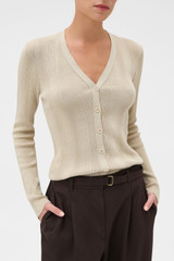 Profile view of model wearing the Oroton Ribbed Cardigan in Almond Creme and 100% Cotton for Women .