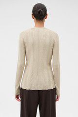 Profile view of model wearing the Oroton Ribbed Cardigan in Almond Creme and 100% Cotton for Women .