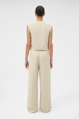 Profile view of model wearing the Oroton Pleat Detail Pant in Almond Creme and 72% viscose and 28% linen blend fabric for Women .