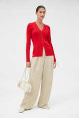 Profile view of model wearing the Oroton Ribbed Cardigan in Ribbon Red and 100% Cotton for Women .