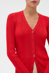Profile view of model wearing the Oroton Ribbed Cardigan in Ribbon Red and 100% Cotton for Women .