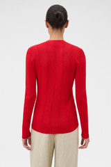 Profile view of model wearing the Oroton Ribbed Cardigan in Ribbon Red and 100% Cotton for Women .