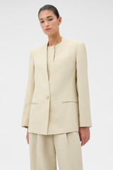 Profile view of model wearing the Oroton Single Breasted Blazer in Almond Creme and 72% Viscose, 28% linen for Women .