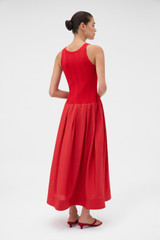 Profile view of model wearing the Oroton Knit Bodice Midi Dress in Ribbon Red and Knit: 100% cotton; Skirt: 77% viscose, 23% polyester for Women .