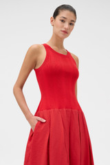 Profile view of model wearing the Oroton Knit Bodice Midi Dress in Ribbon Red and Knit: 100% cotton; Skirt: 77% viscose, 23% polyester for Women .