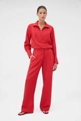 Profile view of model wearing the Oroton Belt Detail Pant in Ribbon Red and 77% viscose and 23% polyamide blend fabric for Women .