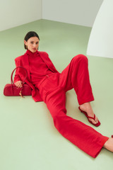 Profile view of model wearing the Oroton Belt Detail Pant in Ribbon Red and 77% viscose and 23% polyamide blend fabric for Women