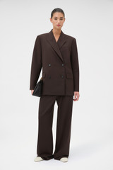Profile view of model wearing the Oroton Double Breasted Blazer in Dark Chocolate and 95% Wool, 5% lycra for Women .