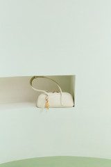 Profile view of model wearing the Oroton Louisa Shoulder Bag in Clotted Cream and Premium smooth leather for Women .