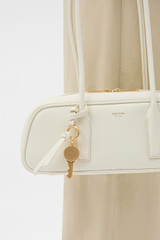 Profile view of model wearing the Oroton Louisa Shoulder Bag in Clotted Cream and Premium smooth leather for Women .