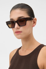 Profile view of model wearing the Oroton Stevie Sunglasses in Chocolate and Acetate material for Women .