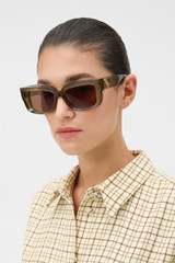 Profile view of model wearing the Oroton Spencer Sunglasses in Khaki Brown Mono and Made from Acetate material for Women .