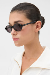 Profile view of model wearing the Oroton Juno Sunglasses in Black and Made from Acetate material for Women .