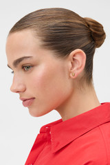 Profile view of model wearing the Oroton Julia Knot Stud in Gold and Premium brass material for Women .
