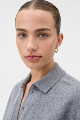 Profile view of model wearing the Oroton Julia Knot Hoop in Silver and Premium brass material for Women .
