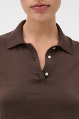 Profile view of model wearing the Oroton Short Sleeve Knit Polo in Bitter Chocolate and 100% Pima cotton yarn fabric for Women .