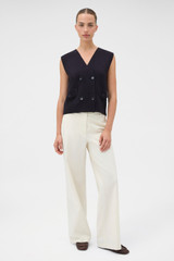 Profile view of model wearing the Oroton Folk Straight Leg Pant in Whipped Cream and 96% cotton and 4% elastane fabric for Women .