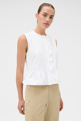 Profile view of model wearing the Oroton Oxford Peplum Top in Antique White and 100% cotton oxford fabric for Women .