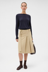 Profile view of model wearing the Oroton Fine Slash Neck Knit in North Sea and 100% Pima cotton yarn fabric for Women .