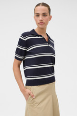 Profile view of model wearing the Oroton Short Sleeve Stripe Knit Polo in North Sea and 100% Pima cotton yarn fabric for Women .