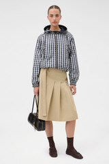 Profile view of model wearing the Oroton Reversible Check Windbreaker in North Sea and 100% polyester fabric for Women .