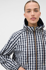 Profile view of model wearing the Oroton Reversible Check Windbreaker in North Sea and 100% polyester fabric for Women .