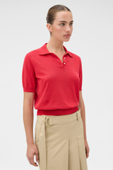 Profile view of model wearing the Oroton Short Sleeve Knit Polo in Market Red and 100% Pima Cotton Yarn for Women .