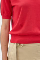 Profile view of model wearing the Oroton Short Sleeve Knit Polo in Market Red and 100% Pima Cotton Yarn for Women .
