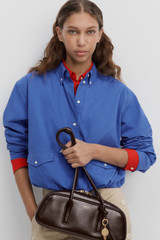 Profile view of model wearing the Oroton Poplin Drawstring Shirt in French Blue and 100% cotton fabric for Women .