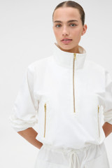 Profile view of model wearing the Oroton Zip Detail Anorak Dress in Antique White and 100% cotton fabric for Women .