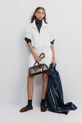Profile view of model wearing the Oroton Zip Detail Anorak Dress in Antique White and 100% cotton fabric for Women
