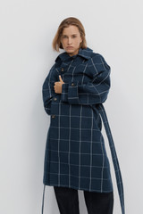 Profile view of model wearing the Oroton Sunday Check Mac in North Sea and 100% cotton fabric for Women .