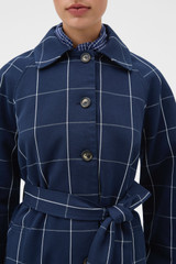 Profile view of model wearing the Oroton Sunday Check Mac in North Sea and 100% cotton fabric for Women .