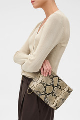 Profile view of model wearing the Oroton Cecile Pouch in Taupe/Black and Premium textured leather for Women .