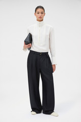 Profile view of model wearing the Oroton Silk Belt Detail Pant in Black and 100% silk fabric for Women .